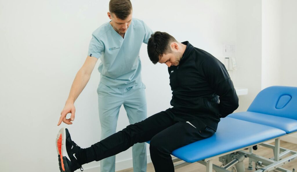 Physiotherapist instructing a patient on rehabilitation exercises in a clinic setting.