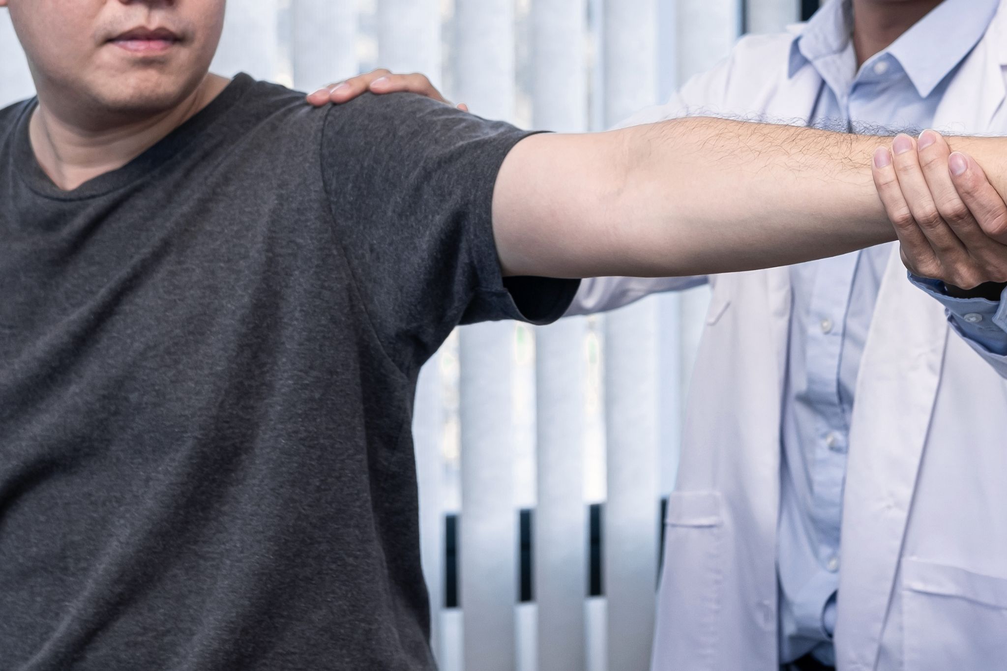 Close-up of a chiropractor's hands applying pressure to a patient's lower back and hip area during an adjustment