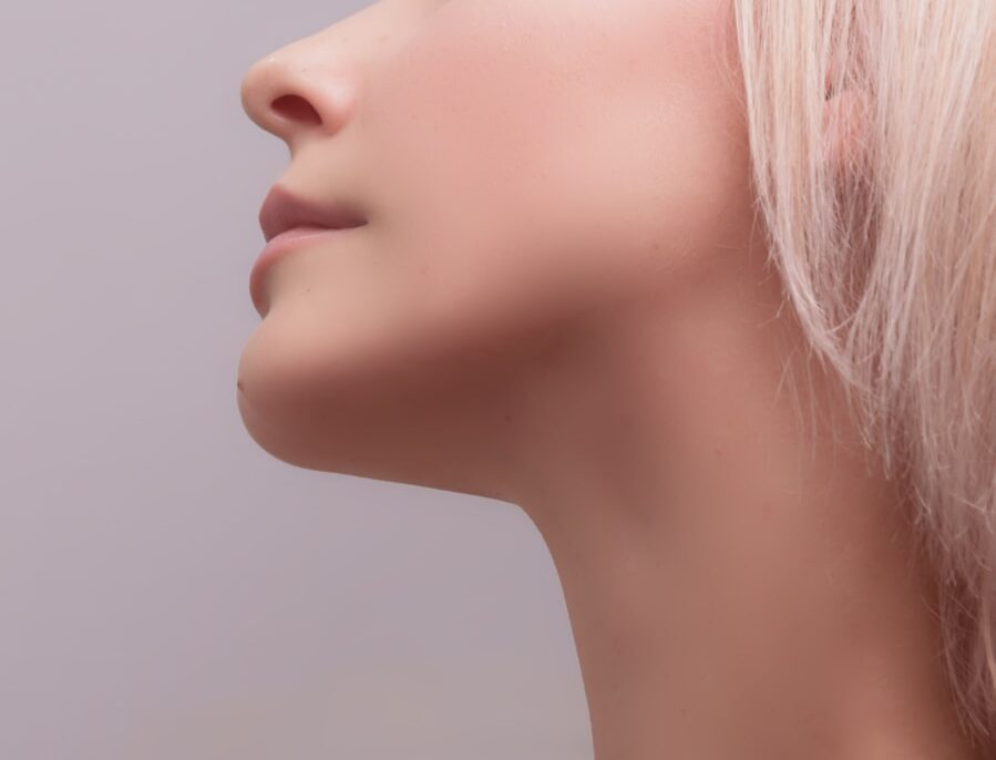 Side profile of a woman focusing on the jawline and neck area, illustrating Temporomandibular Joint (TMJ) and cervical spine alignment for chiropractic treatment.